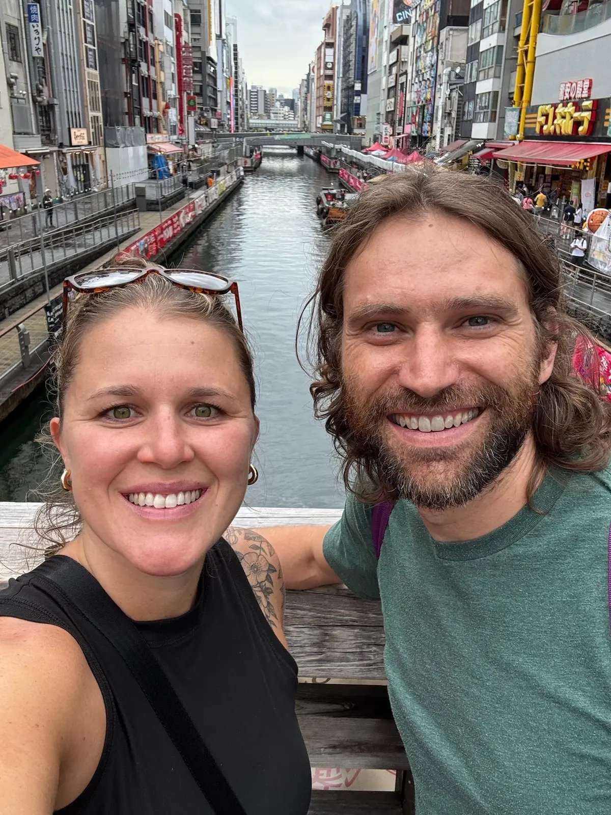 Zach and Caitlin taking a selfie by the Dotonbori canal.