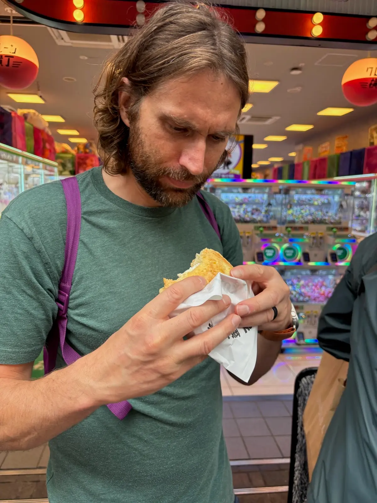 Zach eating a street snack in Dotonbori.