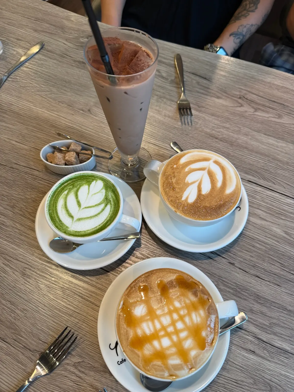 Coffee and matcha drinks on a cafe table before the rainy Kyoto day.