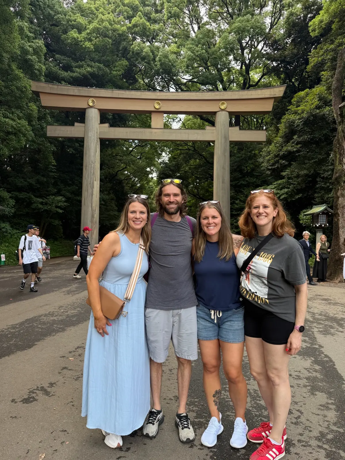 Sarah, Caitlin, Ashley, and Zach standing near a shrine gate in Tokyo.