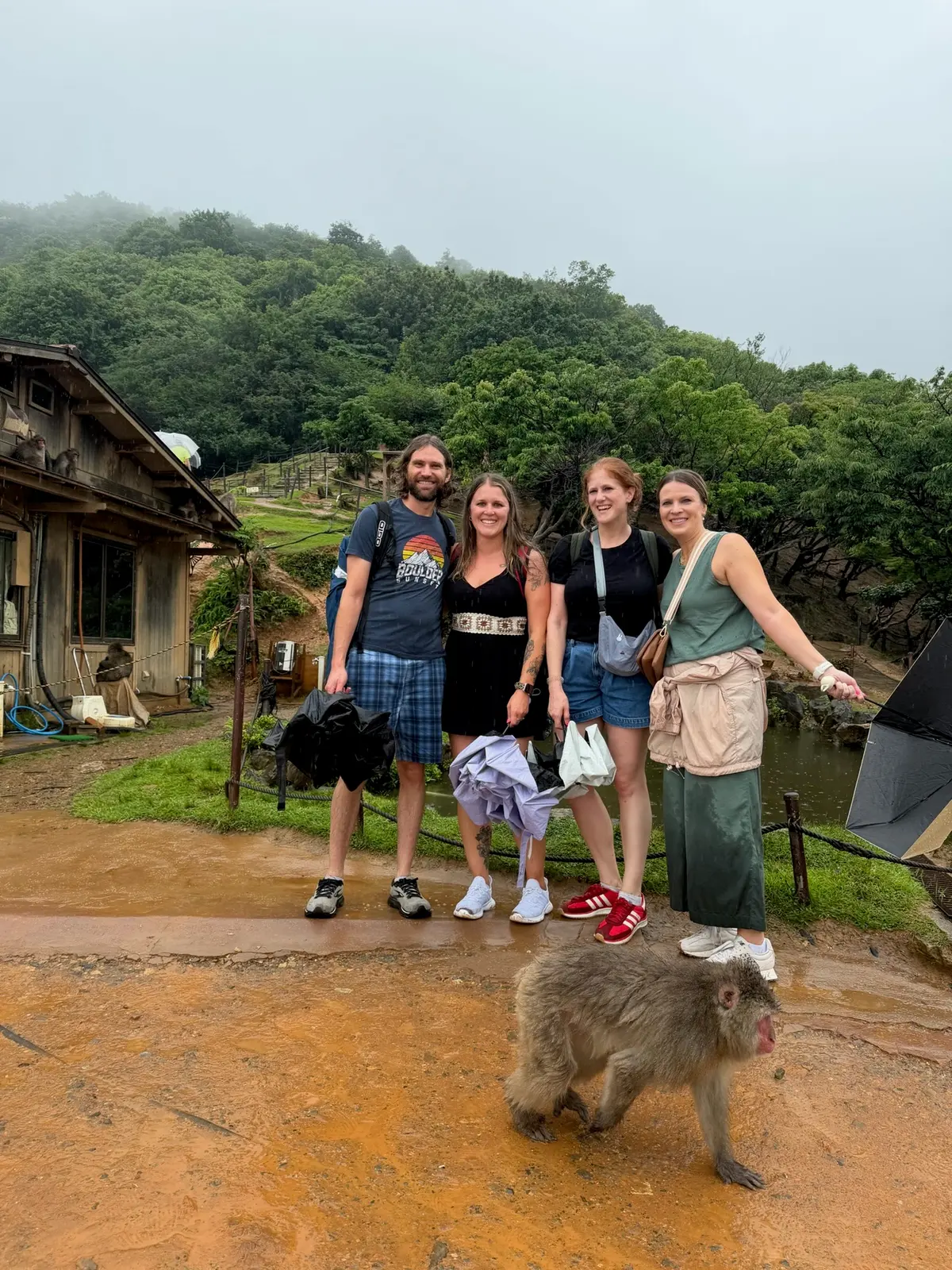 Group photo with a macaque at the rainy monkey park.