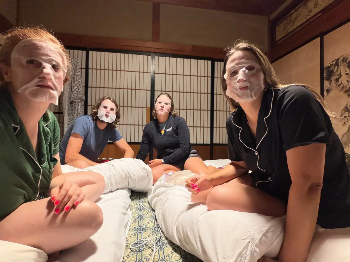 The group wearing sheet masks in the ryokan room.