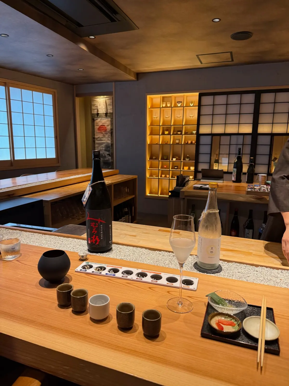Sake tasting setup on a counter in Osaka.